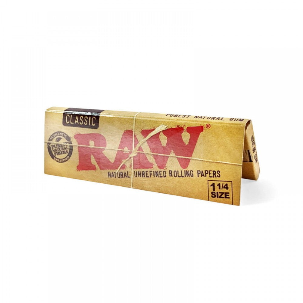 RAW Classic 1¼ Size Rolling Papers with 24 papers per pack, featuring classic RAW branding, lightweight paper, natural brown appearance, and compact packaging.